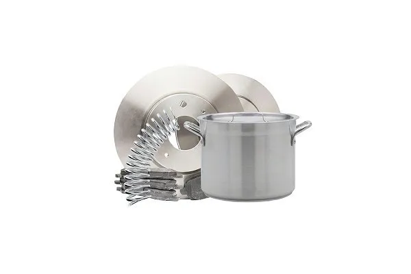 Collection of metal kitchen items including a large stainless steel stockpot, a circular metal lid, and several silver utensils arranged together with a red prohibition symbol over them, indicating these items are not allowed for recycling. 