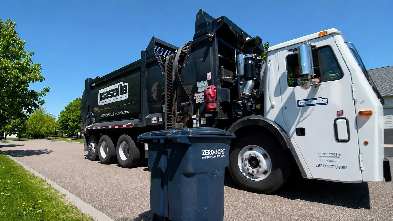 Video tour of a Casella recycling facility showing conveyor belts moving mixed recyclables, automated sorting equipment, and workers in high-visibility safety gear. Scenes highlight the recycling process from curbside collection to material separation, with on-screen tips for proper recycling practices under the Recycle Better™ program. 