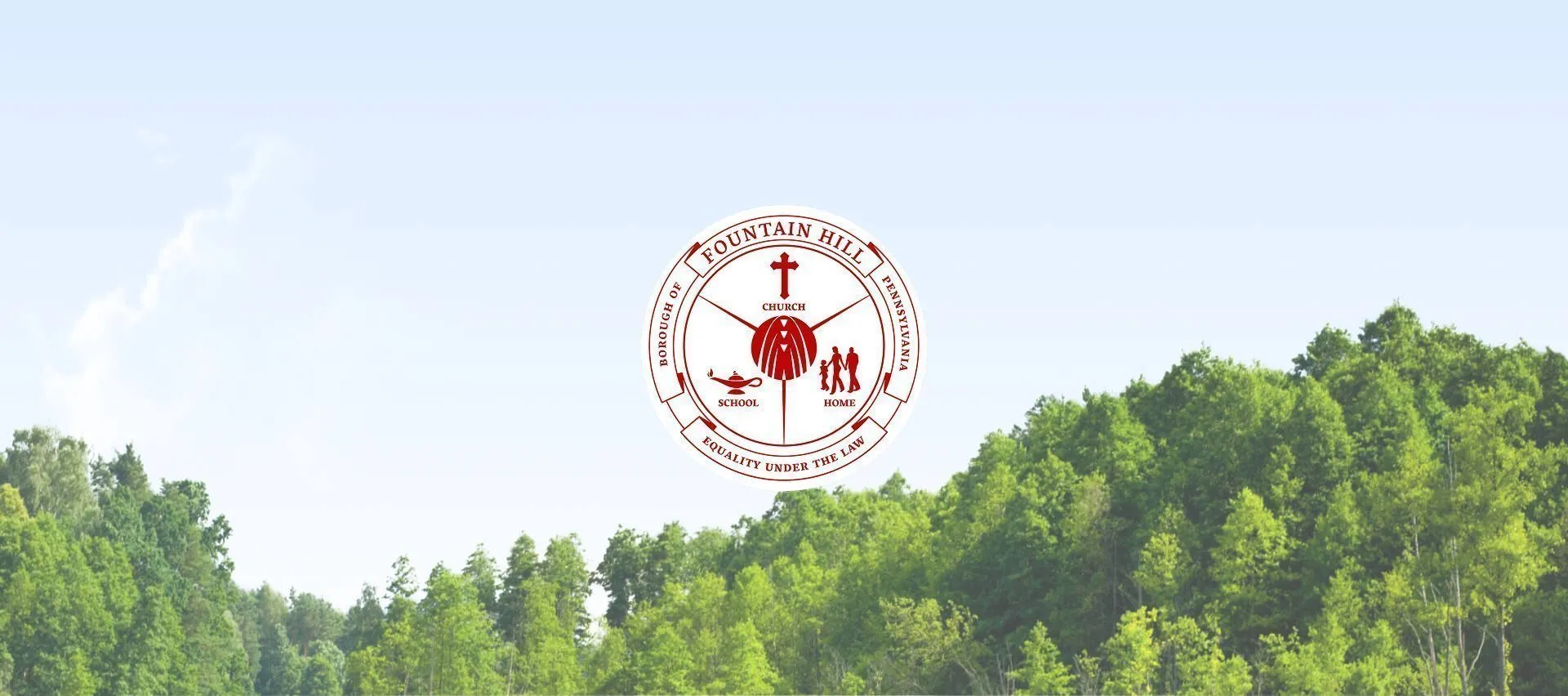 Fountain Hill Borough, Pennsylvania seal centered above a green forested landscape beneath a pale blue sky.