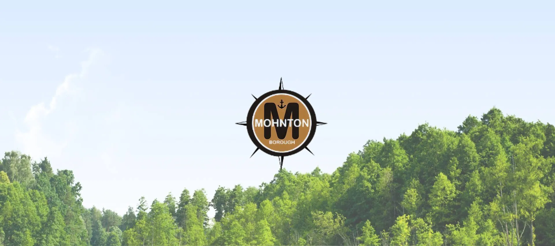 Mohnton Borough logo centered above a green forested landscape beneath a pale blue sky.