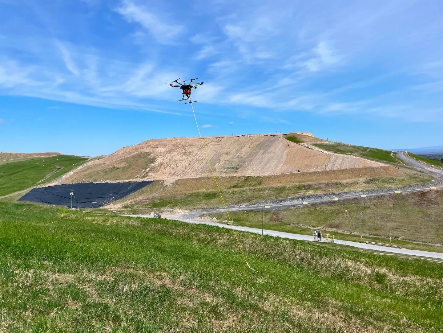A drone flying over a landfill