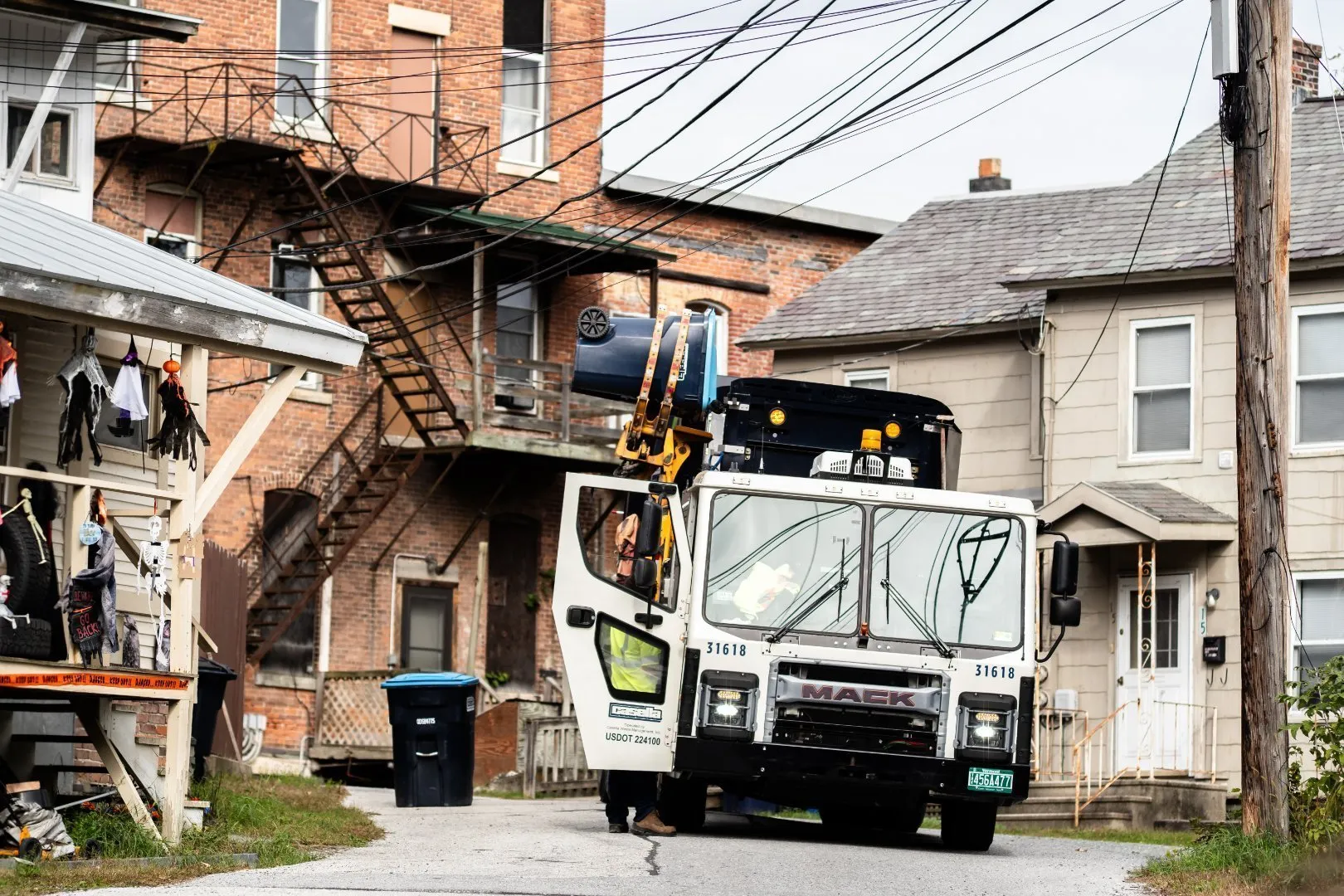 Casella recycling truck servicing residential homes in an urban neighborhood.