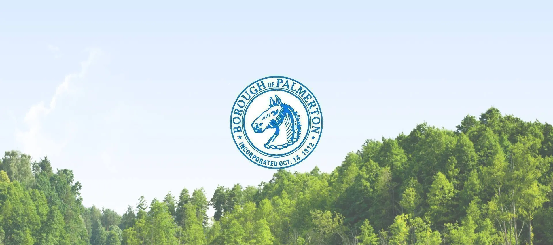 Palmerton Borough seal centered above a green forested landscape beneath a pale blue sky.