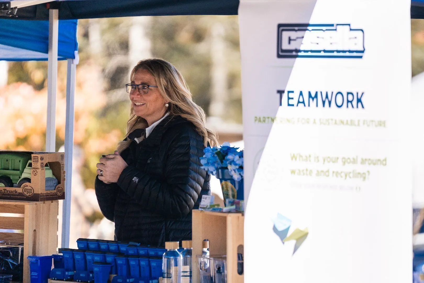 Casella outreach booth at an outdoor event featuring a banner with the word “TEAMWORK” and the tagline “Partnering for a Sustainable Future.”