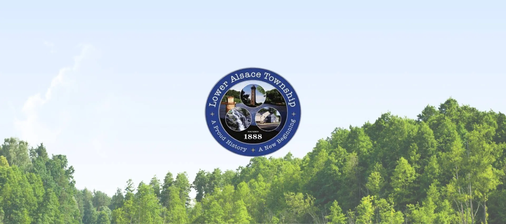 Lower Alsace Township seal centered above a green forested landscape beneath a pale blue sky.