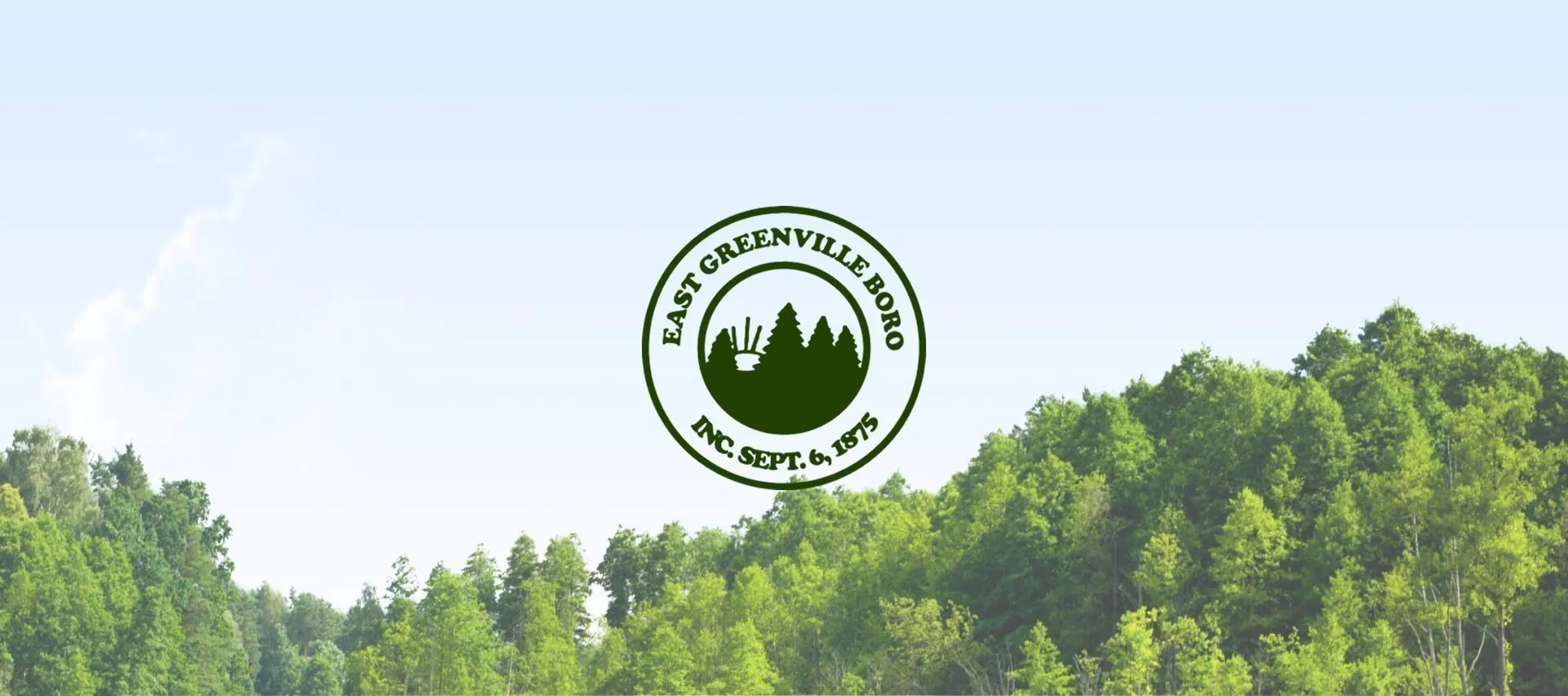East Greenville Borough seal centered above a green forested landscape beneath a pale blue sky.