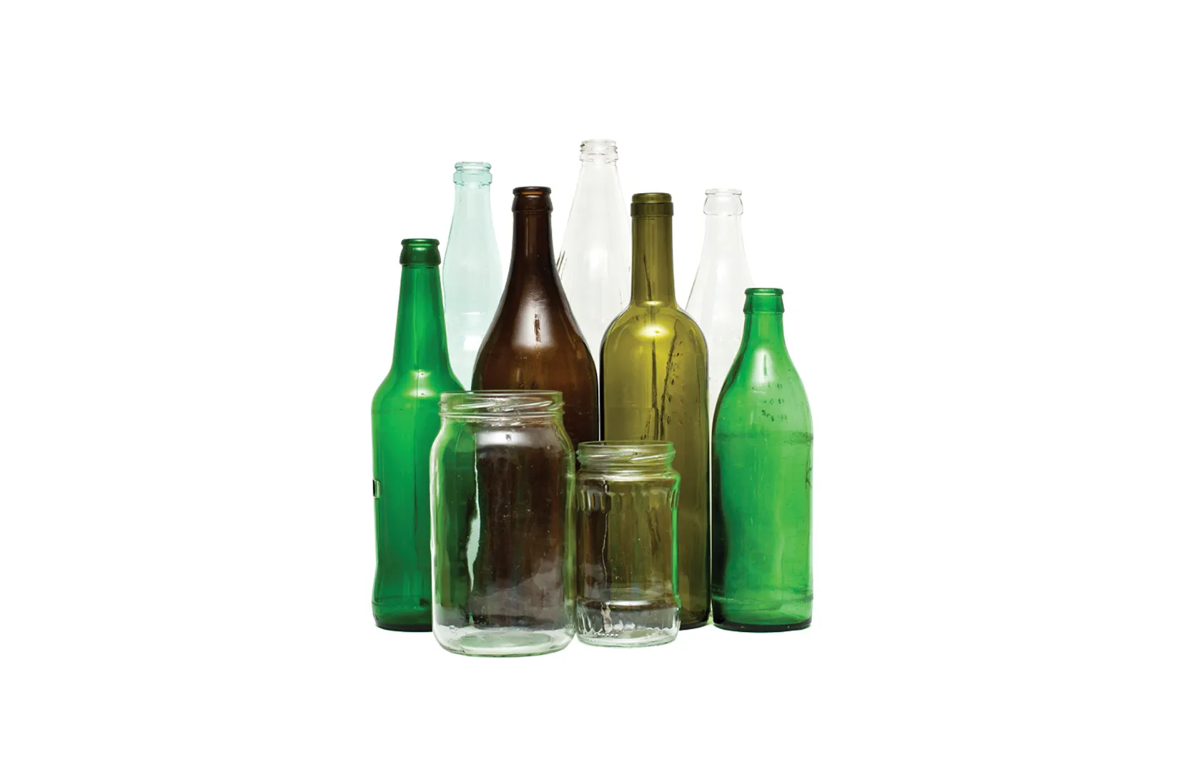 Group of empty glass containers including green, brown, and clear bottles, as well as two clear glass jars, arranged upright on a white background. The bottles vary in size and shape, with some tall and narrow and others short and wide, representing recyclable glass materials. 