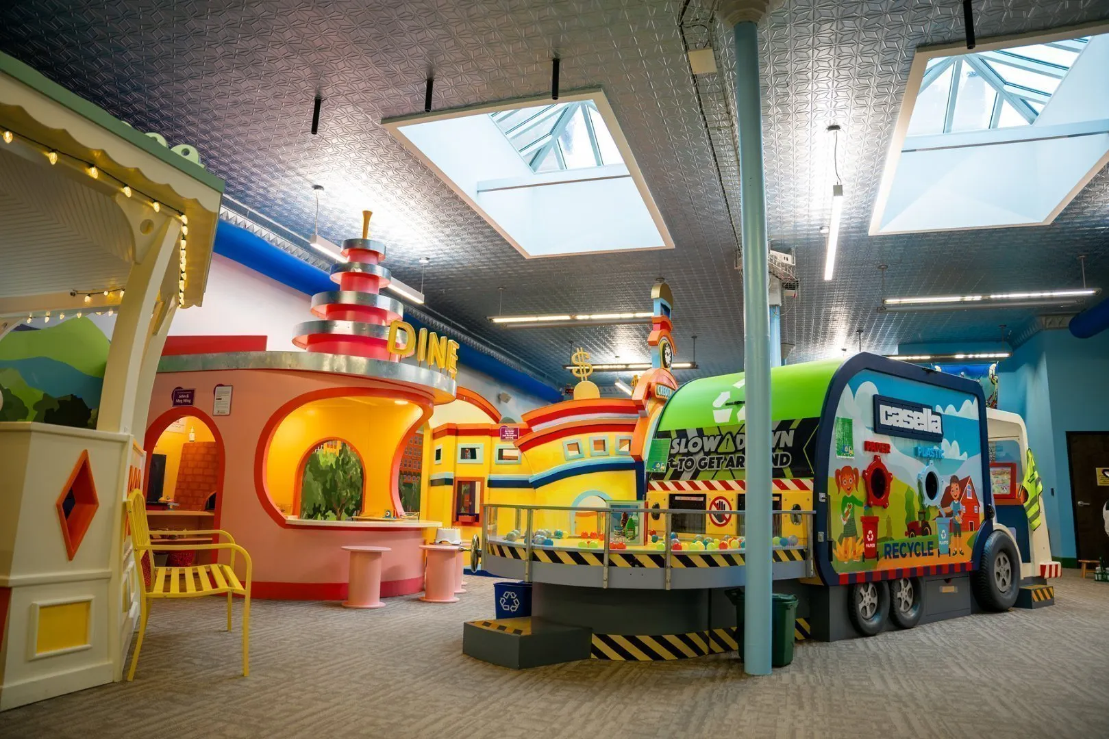 A indoor Casella play place for children with a giant toy garbage truck
