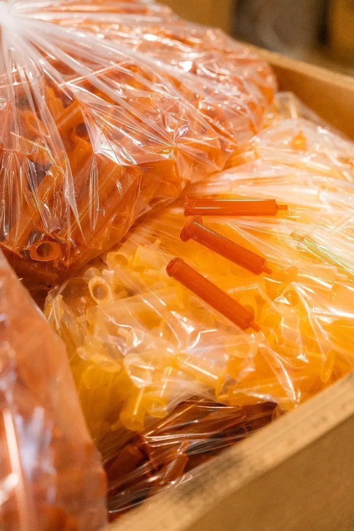 Transparent bags containing empty syringes staged for proper recycling and handling at Casella's specialty recycling facility. 