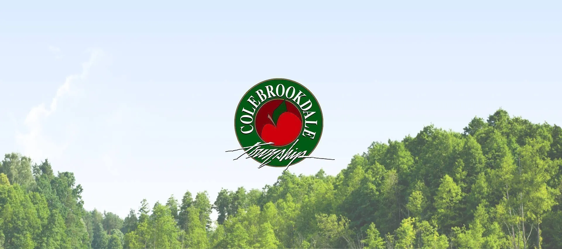 Colebrookdale Township logo centered above a green forested landscape beneath a pale blue sky.