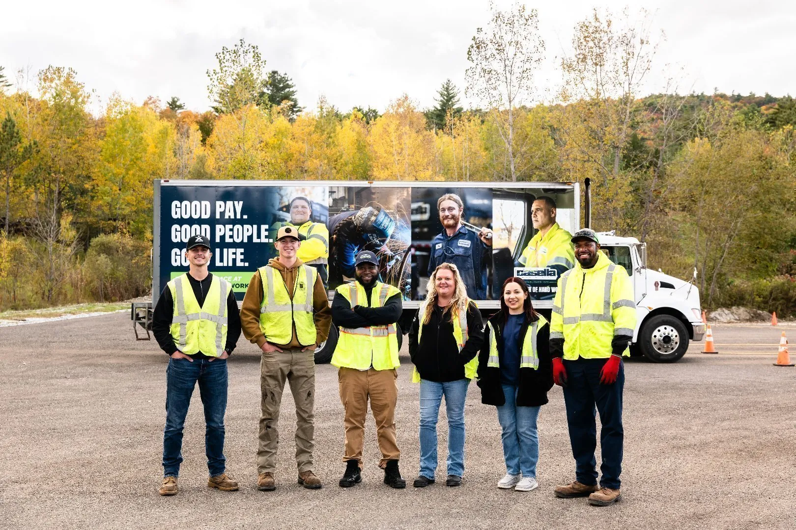 Casella team in high‑visibility vests stands in front of a branded truck displaying “Good Pay. Good People. Good Life.”